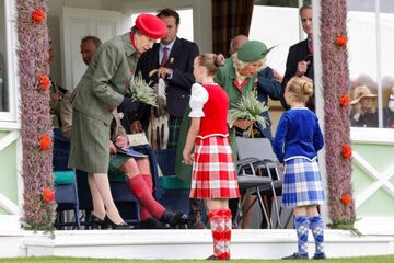 Anne, Princess Royal and Camilla, Duchess of Cornwall present heather posies to Chloe Guy and Cassie Stewart during the Braemar Highland Gathering in Braemar, Scotland. 