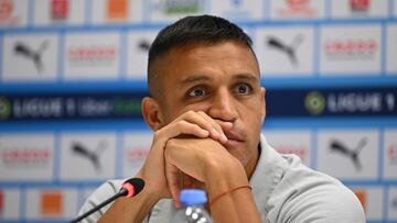 Marseille's Chilean forward Alexis Sanchez reacts as he attends a press conference after the Olympique de Marseille (OM) announced his signing, at Stade Velodrome in Marseille, southern France, on August 10, 2022. - Marseille has announced on August 10, 2022 the signing of Chilean forward Alexis Sanchez, who has played for Barcelona, Arsenal and Inter Milan, and who will bring his talent, goalscoring ability and experience of the highest level to the attack. (Photo by CHRISTOPHE SIMON / AFP)