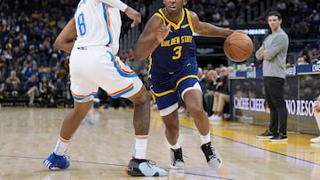 Chris Paul #3 of the Golden State Warriors dribbles the ball while being guarded by Jalen Williams #8 of the Oklahoma City Thunder