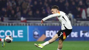 Germany's midfielder #17 Florian Wirtz shoots to score Germany's first goal during the friendly football match between France and Germany, at the Groupama Stadium in Decines-Charpieu, near Lyon, on March 23, 2024. (Photo by FRANCK FIFE / AFP)