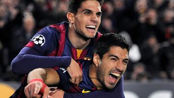 Luis Suarez of FC Barcelona is congratulated by team mate Marc Bartra after scoring during the Champions League Group F match between FC Barcelona and Paris St Germain at the Nou Camp in Barcelona, UK. Photo: Visionhaus/Gary Prior (Photo by Ben Radford/Corbis via Getty Images)