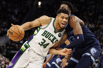 Jan 19, 2022; Milwaukee, Wisconsin, USA; Milwaukee Bucks forward Giannis Antetokounmpo (34) drives for the basket against Memphis Grizzlies forward Jaren Jackson Jr. (13) during the fourth quarter at Fiserv Forum. Mandatory Credit: Jeff Hanisch-USA TODAY 