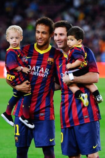 Neymar y Messi con sus hijos.