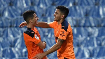 SAN SEBASTIAN, SPAIN - SEPTEMBER 29: Maxi Gomez of Valencia CF celebrates with teammate Hugo Guillamon after scoring his team&#039;s first goal during the La Liga Santander match between Real Sociedad and Valencia CF at Estadio Anoeta on September 29, 202