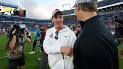 Head coach Peyton Manning of the AFC shakes hands with brother and Head coach Eli Manning of the NFC following the 2024 NFL Pro Bowl Games.