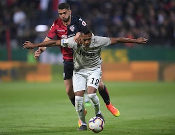 Juventus' Alex Sandro in action with Cagliari's Paolo Farago.