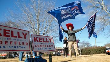 Gary White waves Trump flags during a Senate Firewall campaign rally for Sen. Kelly Loeffler (R-GA) at The Park at City Center on December 29, 2020 in Woodstock, Georgia.