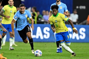 Uruguay's defender #03 Sebastian Caceres fights for the ball with Brazil's forward #09 Endrick during the Conmebol 2024 Copa America tournament quarter-final football match between Uruguay and Brazil at Allegiant Stadium in Las Vegas, Nevada on July 6, 2024. (Photo by Robyn BECK / AFP)