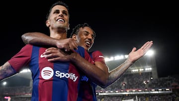 Barcelona's Portuguese defender #02 Joao Cancelo celebrates with Barcelona's French defender #23 Jules Kounde after scoring his team's fifth goal during the Spanish Liga football match between FC Barcelona and Real Betis at the Estadi Olimpic Lluis Companys in Barcelona on September 16, 2023. (Photo by Josep LAGO / AFP)