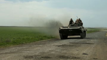 Ukrainian servicemen ride on an armored personnel carrier (APC) on a road near Petrivske village, in Kharkiv region, amid the Russian invasion of Ukraine, on May 9, 2022. (Photo by Anatolii Stepanov / AFP)