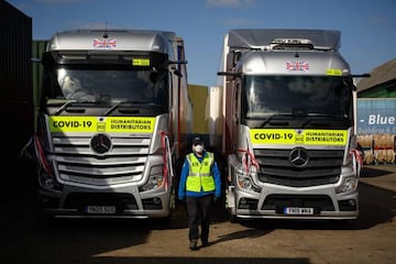 A member of staff for the charity 'His Church' walks past vehicles