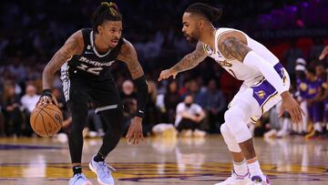 LOS ANGELES, CALIFORNIA - APRIL 22: Ja Morant #12 of the Memphis Grizzlies dribbles in front of D'Angelo Russell #1 of the Los Angeles Lakers during 111-101 Lakers win in Game Three of the Western Conference First Round Playoffs at Crypto.com Arena on April 22, 2023 in Los Angeles, California. NOTE TO USER: User expressly acknowledges and agrees that, by downloading and or using this photograph, User is consenting to the terms and conditions of the Getty Images License Agreement. Harry How/Getty Images/AFP (Photo by Harry How / GETTY IMAGES NORTH AMERICA / Getty Images via AFP)