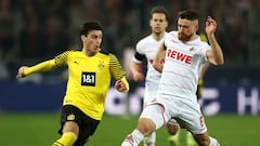 COLOGNE, GERMANY - MARCH 20: Giovanni Reyna of Borussia Dortmund is challenged by Salih Oezcan of 1.FC Koeln during the Bundesliga match between 1. FC K&ouml;ln and Borussia Dortmund at RheinEnergieStadion on March 20, 2022 in Cologne, Germany. (Photo by 