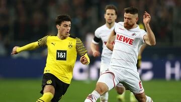 COLOGNE, GERMANY - MARCH 20: Giovanni Reyna of Borussia Dortmund is challenged by Salih Oezcan of 1.FC Koeln during the Bundesliga match between 1. FC K&ouml;ln and Borussia Dortmund at RheinEnergieStadion on March 20, 2022 in Cologne, Germany. (Photo by 