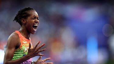 Gold medallist Kenya's Faith Kipyegon reacts as she crosses the finish line in the women's 1500m final of the athletics event at the Paris 2024 Olympic Games at Stade de France in Saint-Denis, north of Paris, on August 10, 2024. (Photo by Anne-Christine POUJOULAT / AFP)