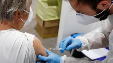 FILE PHOTO: A person receives a dose of the Moderna vaccine against the coronavirus disease (COVID-19) at the Music Auditorium in Rome, Italy, April 14, 2021. REUTERS/Yara Nardi/File Photo