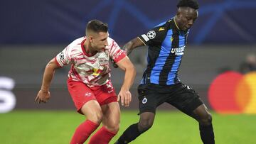 Leipzig's Willi Orban, left, is challenged by Brugge's Kamal Sowah during the Group A Champion's League soccer match between RB Leipzig and Club Brugge at the Red Bull Arena in Leipzig, Germany, Tuesday, Sept. 28, 2021. (AP Photo/Michael So