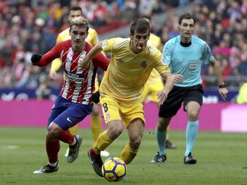 El delantero francés del Atlético de Madrid, Antoine Griezmann, pelea el balón frente al centrocampista español del Girona, Pere Pons 