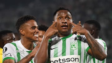 Atletico Nacional's forward #09 Alfredo Morelos (R) celebrates after scoring with teammate Atletico Nacional's defender #16 William Tesillo during the Copa Libertadores group stage first round football match between Colombia's Atletico Nacional and Uruguay's Nacional at the Atanasio Girardot stadium in Medellin, Antioquia department, Colombia, on April 2, 2025. (Photo by Jaime SALDARRIAGA / AFP)