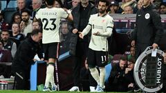 Liverpool's Colombian midfielder Luis Diaz (L) leaves the pitch after being substituted off for Liverpool's Egyptian midfielder Mohamed Salah (R) during the English Premier League football match between Aston Villa and Liverpool at Villa Park in Birmingham, central England on May 10, 2022. (Photo by Paul ELLIS / AFP) / RESTRICTED TO EDITORIAL USE. No use with unauthorized audio, video, data, fixture lists, club/league logos or 'live' services. Online in-match use limited to 120 images. An additional 40 images may be used in extra time. No video emulation. Social media in-match use limited to 120 images. An additional 40 images may be used in extra time. No use in betting publications, games or single club/league/player publications. / 