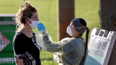 NORTH MIAMI, FLORIDA - JANUARY 13: Lylliette Ramirez gets a COVID-19 test done by a healthcare worker on January 13, 2022 in North Miami, Florida. During the holiday surge people waited in a long line at the North Miami Senior High School site, but today 