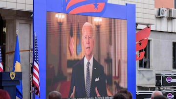 US President Joe Biden appears on screen in Pristina on August 1, 2021, on a pre-tapped message, to accept an award from the President of Kosovo on behalf of his son Beau Biden for his work helping to strengthen the war-torn country&#039;s justice system.