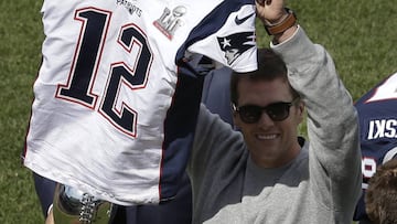 New England Patriots quarterback Tom Brady displays his recovered jersey, which was stolen from the locker room after the Patriots&#039; February Super Bowl victory over the Atlanta Falcons in Houston, during pregame ceremonies before a baseball game between the Boston Red Sox and the Pittsburgh Pirates on opening day at Fenway Park, Monday, April 3, 2017, in Boston. (AP Photo/Steven Senne)