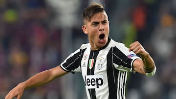 (FILES) This file photo taken on April 11, 2017 shows Juventus' forward from Argentina Paulo Dybala celebrating after scoring during the UEFA Champions League quarter final first leg football match Juventus vs Barcelona, on April 11, 2017 at the Juventus stadium in Turin. Dybala has extended his contract with Juventus Turin with which he is now linked until 2022, announced on April 13, 2017 the Italian club. / AFP PHOTO / GIUSEPPE CACACE