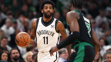 (FILES) In this file photo taken on April 17, 2022, Kyrie Irving, #11 of the Brooklyn Nets, dribbles downcourt against Jaylen Brown, #7 of the Boston Celtics, during the first quarter of Round 1 Game 1 of the 2022 NBA Eastern Conference Playoffs at TD Garden in Boston, Massachusetts. - Brooklyn Nets guard Kyrie Irving was fined $50,000 by the NBA on April 19, 2022, for directing obscene gestures and profane language at spectators, the league announced. (Photo by Maddie Meyer / GETTY IMAGES NORTH AMERICA / AFP)