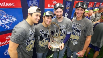 TORONTO, ONTARIO - NOVEMBER 02: (L-R) Shohei Ohtani #17, Yoshinobu Yamamoto #18, Blake Snell #7, and Tyler Glasnow #31 of the Los Angeles Dodgers pose with the Commissioner's Trophy in the locker room after defeating the Toronto Blue Jays 5-4 in game seven to win the 2025 World Series at Rogers Center on November 02, 2025 in Toronto, Ontario. Gregory Shamus/Getty Images/AFP (Photo by Gregory Shamus / GETTY IMAGES NORTH AMERICA / Getty Images via AFP)
