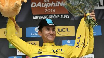 Poland&#039;s Michal Kwiatkowski celebrates his overall leader&#039;s yellow jersey on the podium at the end of a 6,6 km individual time-trial, the prologue of the 70th edition of the Criterium du Dauphine cycling race on June 3, 2018 in and around Valenc