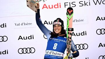 First-placed Italy's Federica Brignone celebrates on the podium of the Women's SuperG race at the FIS Alpine Skiing World Cup event in Val-d'Isere, in the French Alps, on December 17, 2023. (Photo by Jeff PACHOUD / AFP)