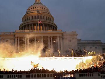 FILE PHOTO: An explosion caused by a police munition is seen while supporters of U.S. President Donald Trump gather in front of the U.S. Capitol Building in Washington, U.S., January 6, 2021. REUTERS/Leah Millis/File Photo