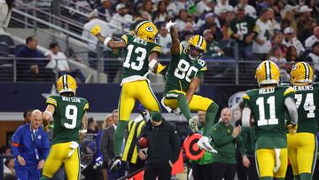 ARLINGTON, TEXAS - JANUARY 14: Dontayvion Wicks #13 and Bo Melton #80 of the Green Bay Packers celebrate a touchdown during the second quarter of the NFC Wild Card Playoff game against the Dallas Cowboys at AT&T Stadium on January 14, 2024 in Arlington, Texas.   Richard Rodriguez/Getty Images/AFP (Photo by Richard Rodriguez / GETTY IMAGES NORTH AMERICA / Getty Images via AFP)