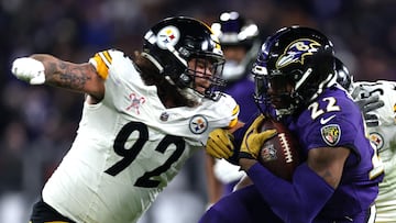 BALTIMORE, MARYLAND - DECEMBER 21: Derrick Henry #22 of the Baltimore Ravens is tackled by Isaiahh Loudermilk #92 of the Pittsburgh Steelers during the third quarter at M&T Bank Stadium on December 21, 2024 in Baltimore, Maryland. Rob Carr/Getty Images/AFP (Photo by Rob Carr / GETTY IMAGES NORTH AMERICA / Getty Images via AFP)