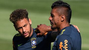 Brazil's striker Neymar (L) and Brazil's midfielder Paulinho (R) speak together as they take part in a training session of the Brazilian national football team at the Yug Sports stadium in Sochi, on June 13, 2018 ahead of the Russia 2018 World C