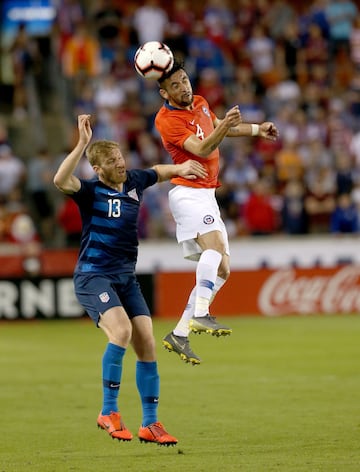 Mar 26, 2019; Houston, TX, USA; Chile defender Isla Mauricio (4) heads the ball away from United States of America defender Tim Ream (13) in the first half during an international friendly soccer match at BBVA Compass Stadium. Mandatory Credit: Thomas B. Shea-USA TODAY Sports