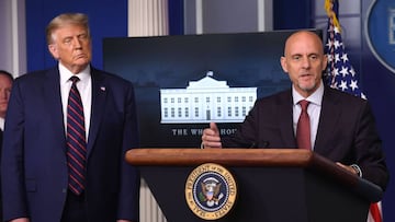 FDA Commissioner Stephen Hahn speaks as US President Donald Trump looks on during a press conference in the Press Briefing Room of the White House in Washington, DC, August 23, 2020. - American authorities announced an emergency approval of blood plasma from recovered coronavirus patients as a treatment against the disease that has killed over 176,000 in the US. (Photo by SAUL LOEB / AFP)