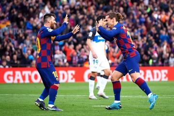 Antoine Griezmann celebrates with his teammate Lionel Messi after scoring the opening goal during against Alavés.