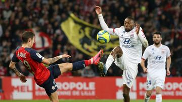 FILE PHOTO: Soccer Football - Ligue 1 - Lille v Olympique Lyonnais - Stade Pierre-Mauroy, Lille, France - March 8, 2020 Olympique Lyonnais' Karl Toko Ekambi in action with Lille's Domagoj Bradaric REUTERS/Francois Walschaerts/File Photo