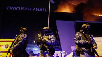 El Crocus City Hall, a las afueras de Moscú, en llamas tras el atentado perpetrado por un grupo de personas vestidas camuflaje y armas de asalto. En la imagen, fuerzas de seguridad rusas desplegadas a las puertas del recinto.