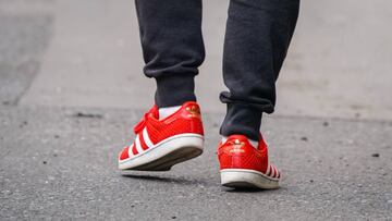 PARIS, FRANCE - MAY 14: A passerby wears red Adidas sneakers shoes, in the streets of Paris, on May 14, 2020 in Paris, France. (Photo by Edward Berthelot/Getty Images)