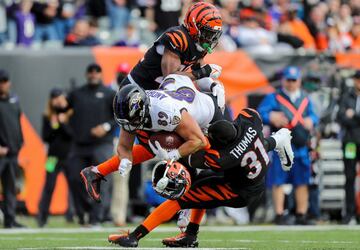 La defensa de los Bengals tuvo que emplearse a fondo en el triunfo ante los Ravens (41-21) para frenar a Mark Andrews, tight end de Baltimore. En la imagen es placado por Awuzie y Thomas, quien perdiÃ³ el casco en el violento impacto.