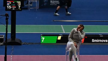 Russia's Anna Smirnova, registered as an Individual Neutral Athlete (AIN), sits on the fencing strip in protest, after Ukraine's Olga Kharlan (not in picture), refused to shake hands with her, after Kharlan defeated her during the Sabre Women's Senior Individual qualifiers, as part of the FIE Fencing World Championships at the Fair Allianz MI.CO (Milano Convegni) in Milan, on July 27, 2023. (Photo by Andreas SOLARO / AFP)