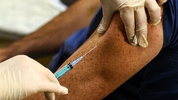 A nurse proceeds to a vaccination against the coronavirus disease (COVID-19) by Sputnik V (Gam-COVID-Vac) vaccine at a clinic in Moscow on December 5, 2020, amid the ongoing coronavirus disease pandemic. - Russian President has told authorities to begin "large-scale" vaccinations among at-risk populations. The drugs should be made generally available to the Russian public in early 2021. (Photo by Kirill KUDRYAVTSEV / AFP)