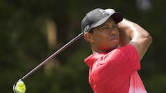 Tiger Woods watches his shot after teeing off on the 2nd hole in the final round of the Quicken Loans National golf tournament at Robert Trent Jones Golf Club in Gainesville, Virginia