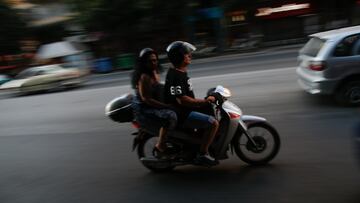 A man and a woman are seen riding a moped in downtown Thessaloniki on 3 August, 2017. (Photo by Jaap Arriens/NurPhoto via Getty Images)