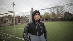 A resident stands outside the soccer field in the Villa Azul neighborhood on the outskirts of Buenos Aires, Argentina, Monday, May 25, 2020, as health officials isolate the area for quarantine after over 50 residents tested positive for the new coronavirus. According to neighbors, the virus spread at their local soccer field where games continued after the government mandated a lockdown in March to curb the spread of COVID-19. (AP Photo/Natacha Pisarenko)
