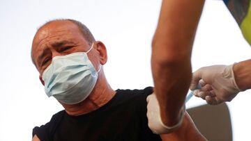 A man receives an injection with AstraZeneca's COVID-19 vaccine at a vaccination centre, at the Wanda Metropolitano stadium, in Madrid, Spain, March 31, 2021. REUTERS/Susana Vera