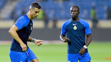 Nassr's Portuguese forward #07 Cristiano Ronaldo and Nassr's Senegalese Forward #10 Sadio Mane warm up before the Saudi Pro League football match between Al-Nassr and Al-Fateh at the Prince Abdullah Bin Jalawi Stadium in al-Hasa, on August 25, 2023. (Photo by Ali Al-HAJI / AFP)